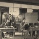 Black-and-white photo of men at tables in a laboratory