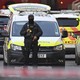 An armed police officer stands in front of a police car in the London Bridge area of the British capital.