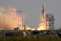 The New Shepard Blue Origin rocket lifts-off from the launch pad