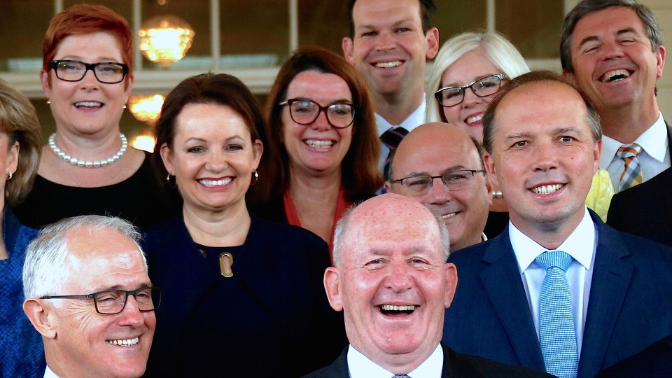 Matt Canavan (top), Australia's resources minister, smiles as he stands behind Prime Minister Malcolm Turnbull, Governor General Peter Cosgrove, and other members of the ministry as they pose for an official photograph in Canberra on July 19, 2016.