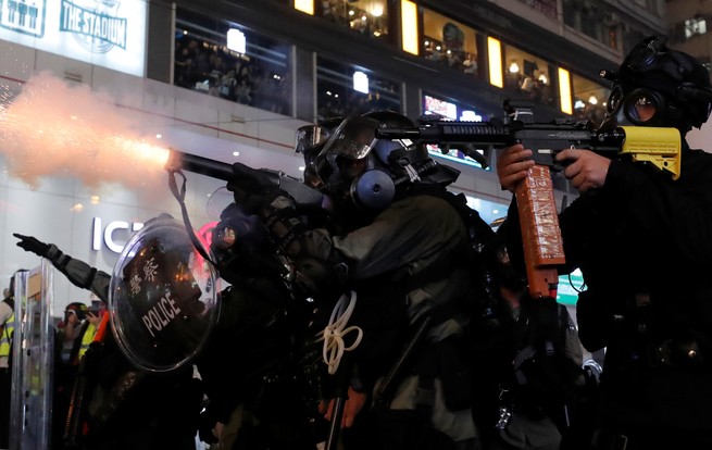 Police officers fire tear gas at a demonstration in Hong Kong.