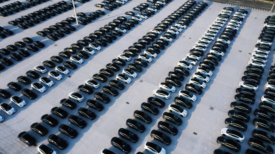 rows of hundreds of black and white cars
