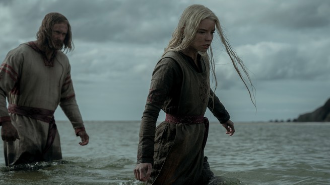 Alexander Skarsgård and Anya Taylor-Joy wading through water in "The Northman"