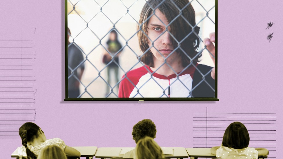 A frame from the documentary "Bad Kids" fills the screen of a projector in a classroom.