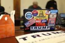 A computer covered in pro-Trump stickers sits on a table at a campaign office in New Hampshire