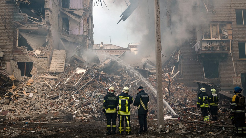Firefighters and rescue workers at the scene of a Russian missile strike on Zaporizhzhia, Ukraine