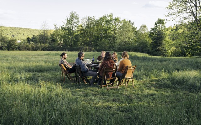 People sitting a table in a park