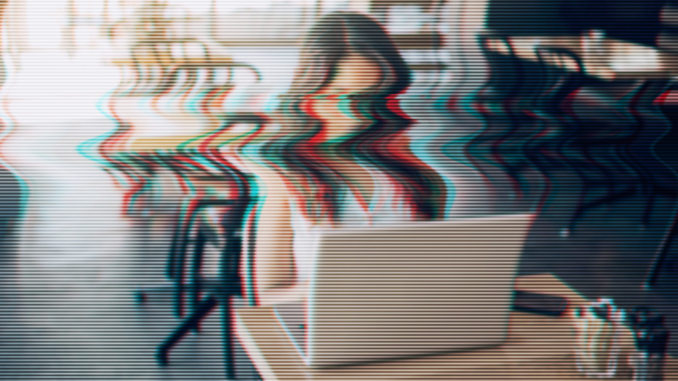 Distorted image of a woman at a laptop