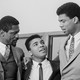 a black-and-white photo of Bill Russell, Muhammad Ali, and Kareem Abdul-Jabbar