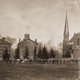 People stand on Wesleyan's college quad, near the campus's gothic Memorial Chapel.