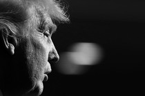 Black-and-white photograph of Donald Trump in profile from the right, with the background out of focus