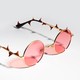 Photo illustration of rose colored glasses with thorns on them