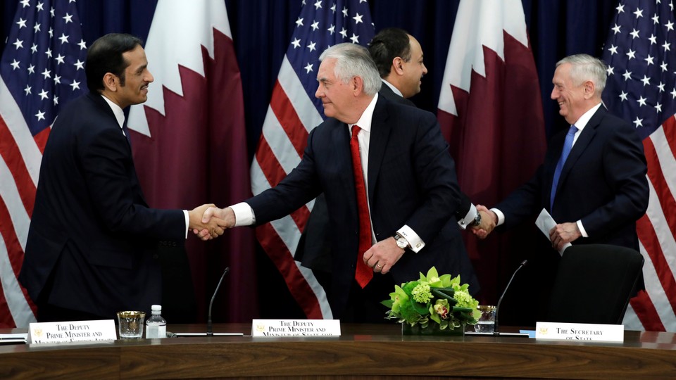 The U.S. secretaries or state and defense shake hands with their Qatari counterparts in Washington. 
