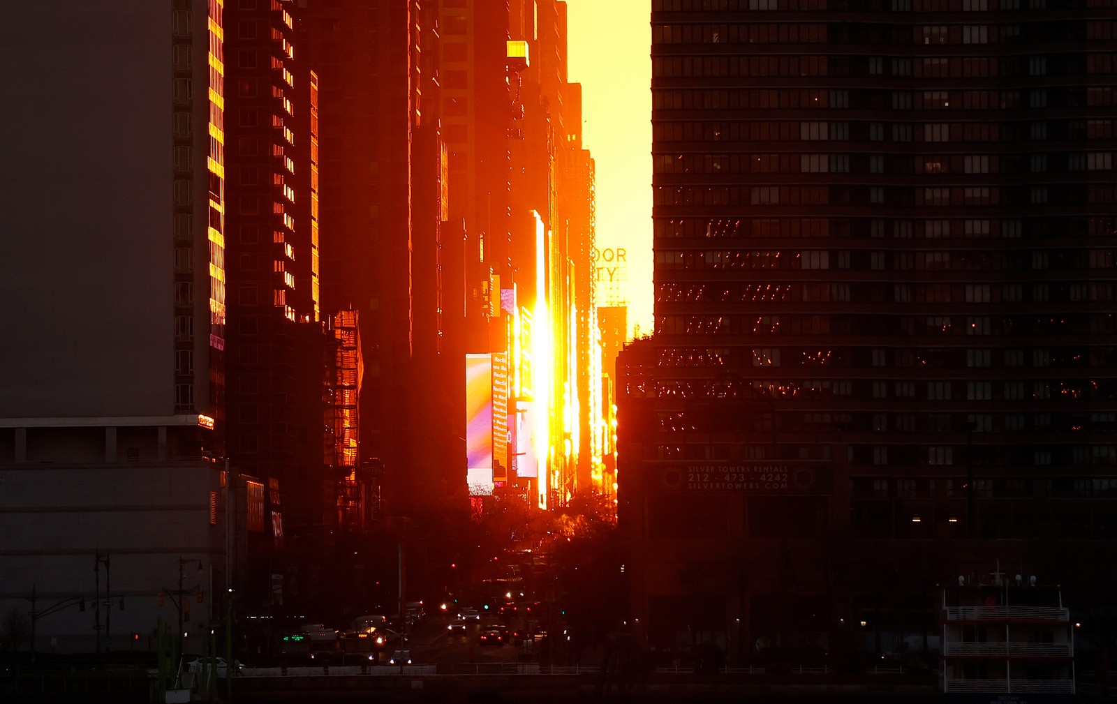 The light of a sunrise reflects off tall buildings in New York City.