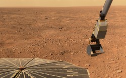 The robotic arm on the Phoenix Mars Lander picking up a scoop of soil from the surface of Mars