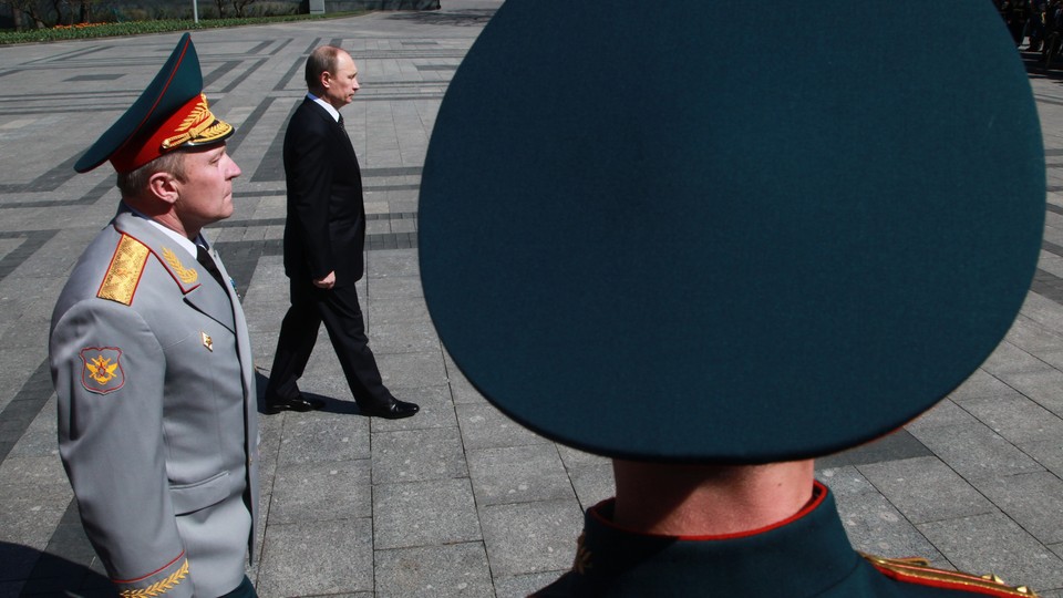Putin walking with army officials