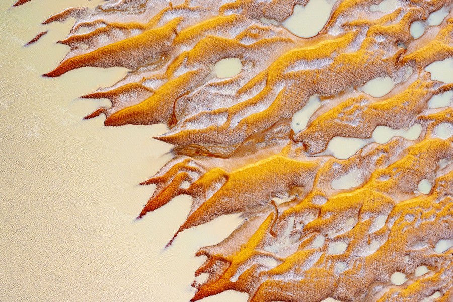 An aerial view of interlaced sand formations.