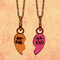 two "Best Friend" necklaces, each with half a heart, hanging side by side with all text except "End" crossed out