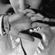 A woman holds her hand to her mouth.