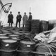 Prohibition agents examining barrels on boat, c. 1925.