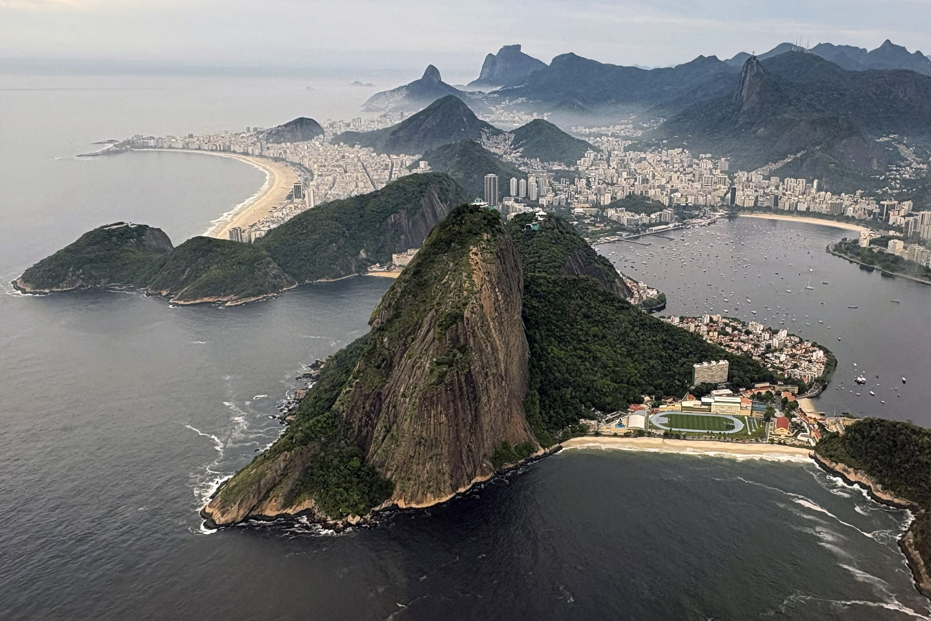 An aerial view of the mountains, harbors, and buildings of Rio de Janeiro