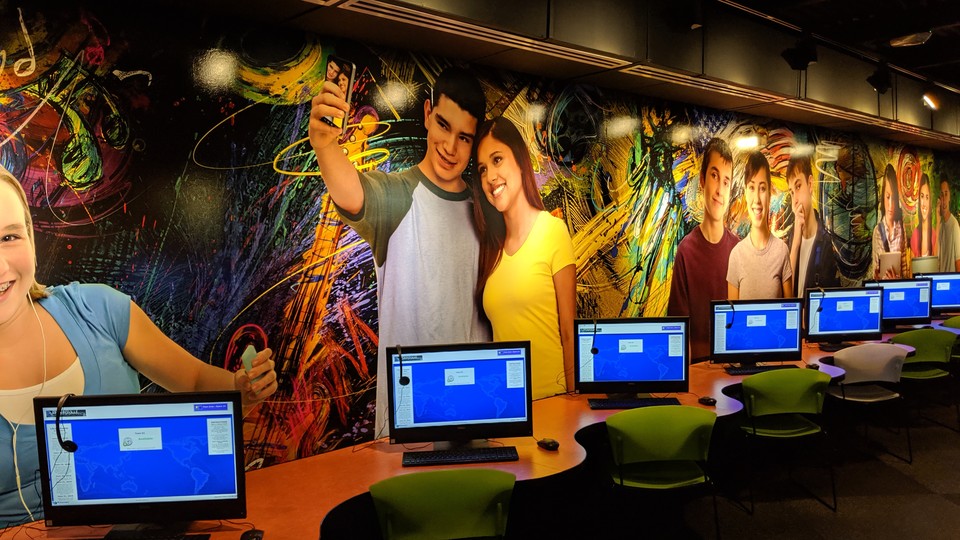 Murals of teenagers on the wall of the teen space in the Brownsville Public Library's main branch