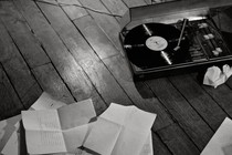 A record player and notes strewn across the floor