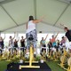 People ride yellow stationary bikes in an outdoor SoulCycle class.