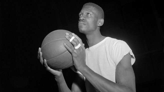 Bill Russell eyeing the hoop with basketball in hand.