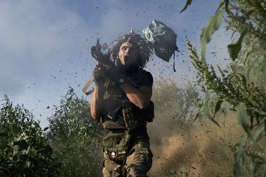 A soldier reacts as they fire a shoulder-mounted weapon.