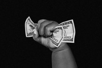 An illustration of a baby hand holding money.
