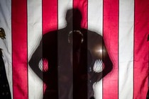 A news photo of a looming shadow of Donald Trump's figure.