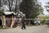 A man surveys a damaged home in Ukraine.