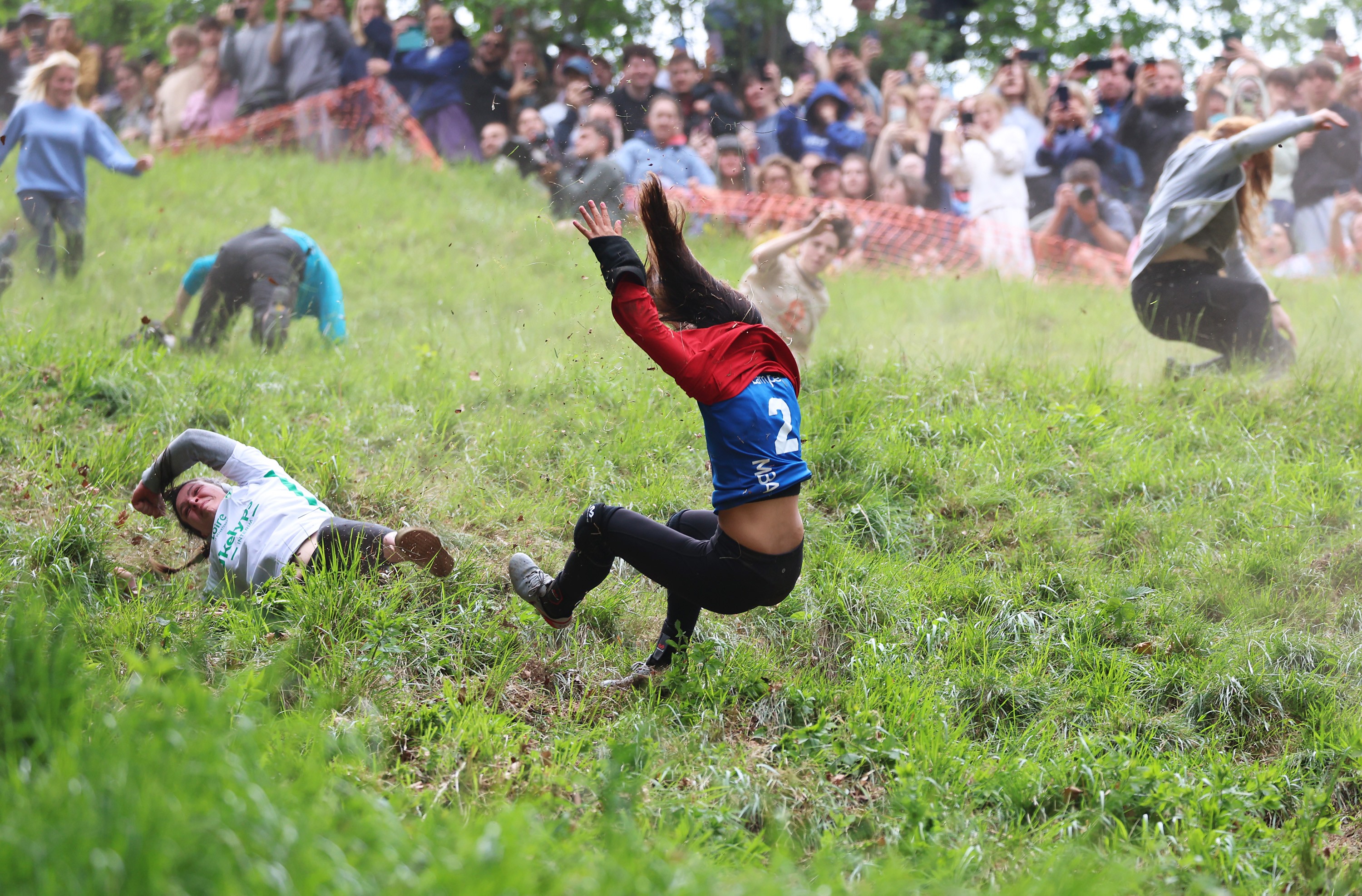 The competitor fell down his head in a steep grassy mountain match.