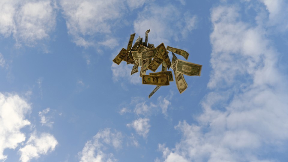Dollar bills float against a blue sky