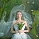 A still from Melancholia showing Kirsten Dunst in a wedding dress floating in a river