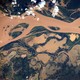 An aerial view of a muddy river.