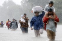 Houston residents wade through floodwaters and heavy rain.