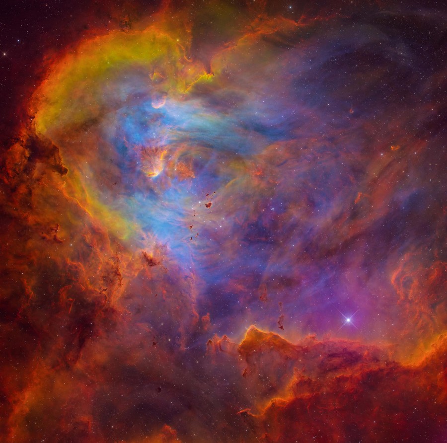 Clouds of gas and dust glow in a close view of a nebula.