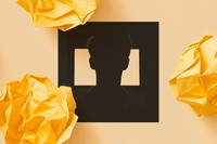 A black-and-white photo shows the silhouette of a young boy looking at a glowing screen.