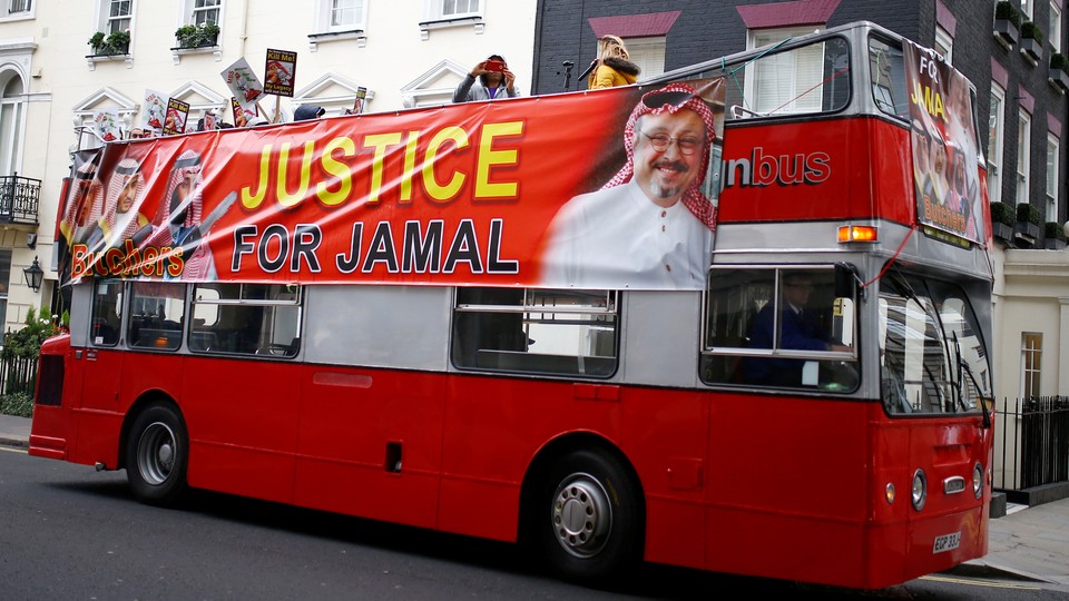 A double-decker bus in London bears a banner calling for justice following the death of Jamal Khashoggi.