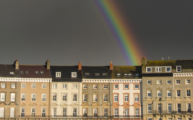 Photograph of a rainbow over houses in the UK