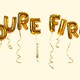 An illustration of gold balloons spelling "YOURE FIRED"