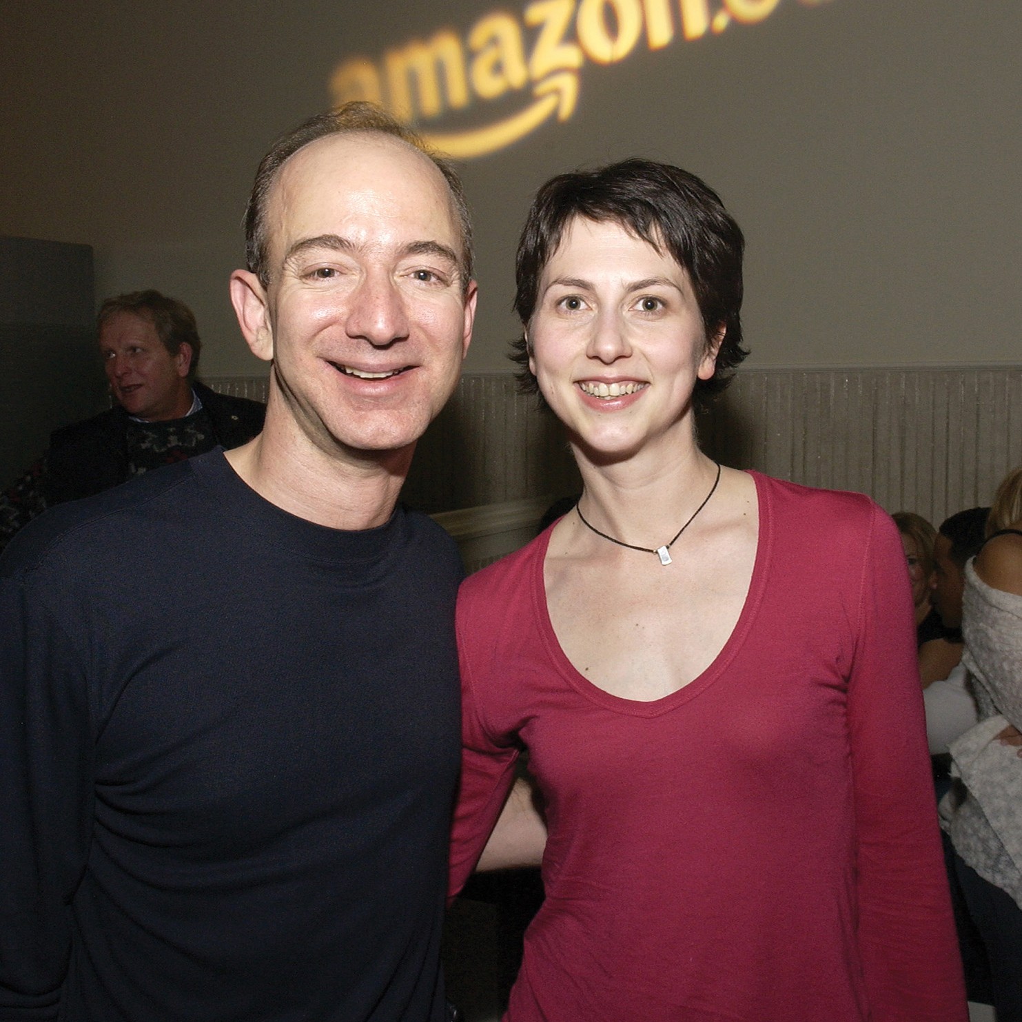 couple at event with arms around each other and Amazon logo in background