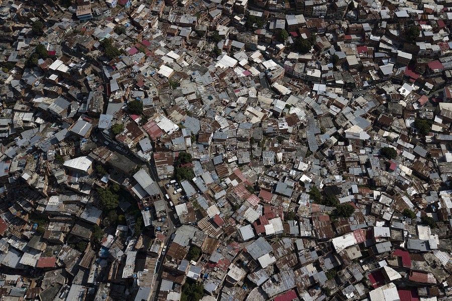An aerial view of many small homes built close together on a hilltop.