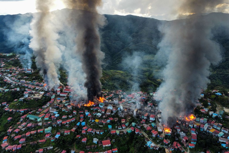 Smoke rises from several fires burning in a hilltop town.