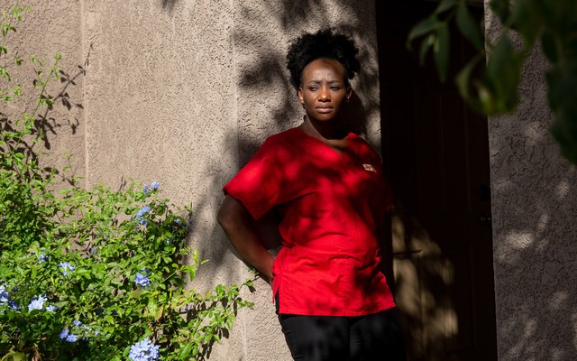 Mawata Kamara leans against a wall.