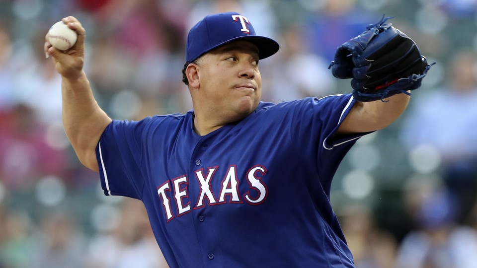 The Texas Rangers starting pitcher Bartolo Colon (40) throws during the first inning against the New York Yankees at Globe Life Park in Arlington on May 22