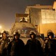 Riot-police officers guard the Cairo Security Directorate from protesters in 2016