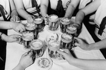 People in a circle holding beers